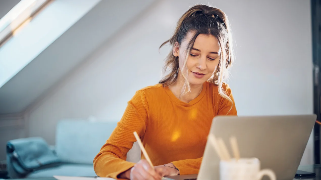 Woman working from a home on her a laptop