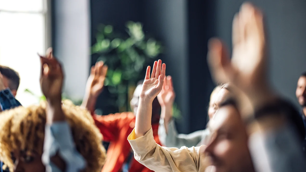 Group of Anonymous People Raising Hands on a Seminar