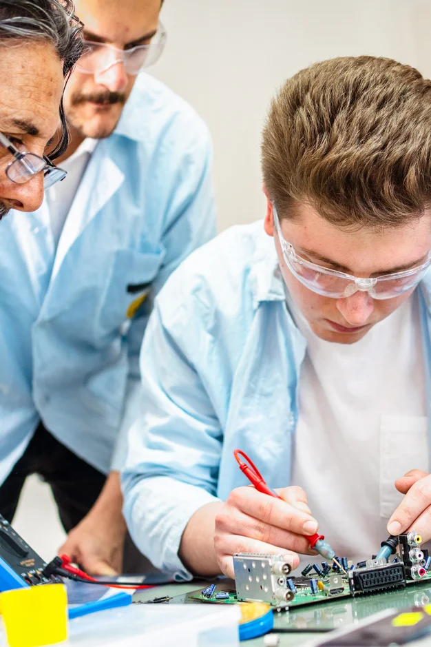 Group of young people in technical vocational training with teacher