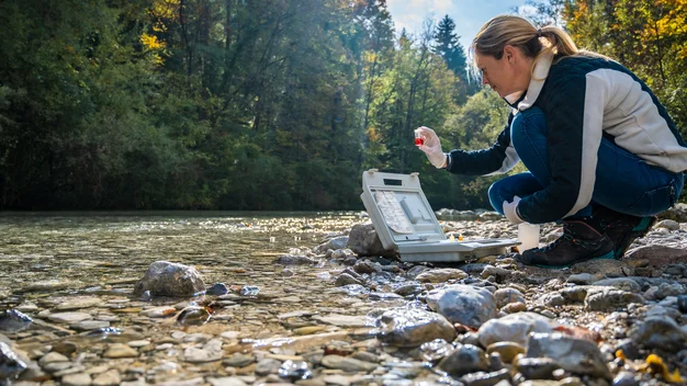 Female biologist testing water sample