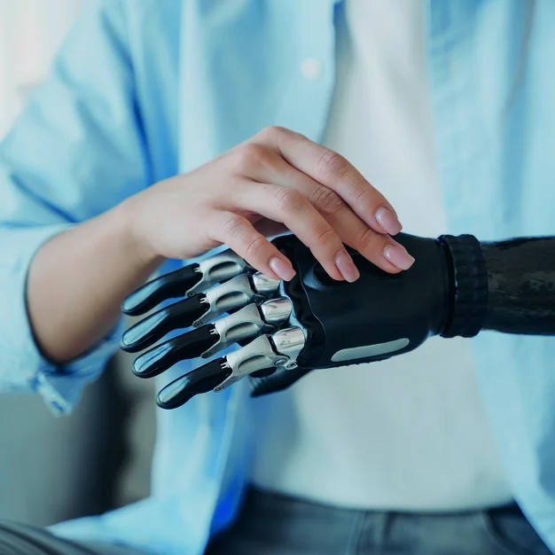 1407731933 Cyber hand of female amputee. Disabled woman is changing settings of robotic prosthesis.
